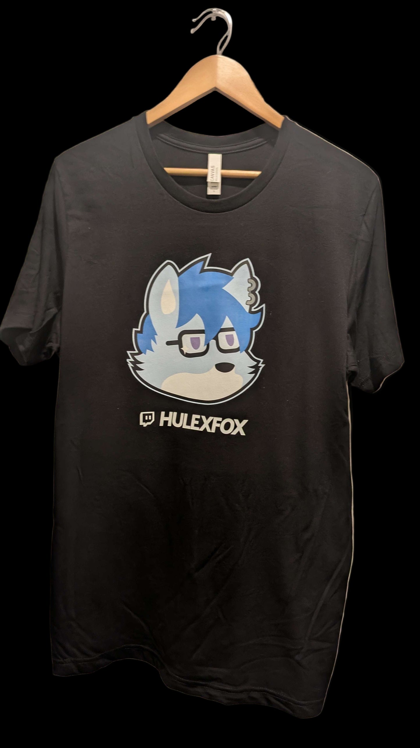 Black t-shirt with a graphic design and 'HULEXFOX' text on a white door background